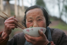 Old woman eating, Yiwu, China